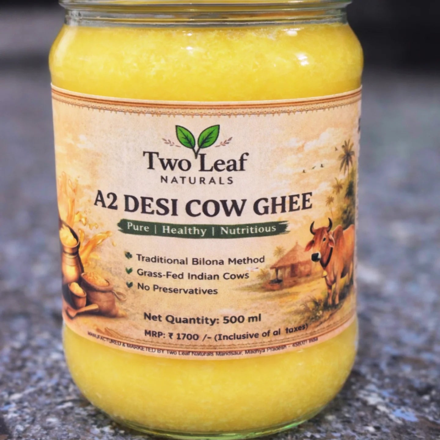 Jar of Two Leaf Naturals A2 Desi Cow Ghee on a textured surface