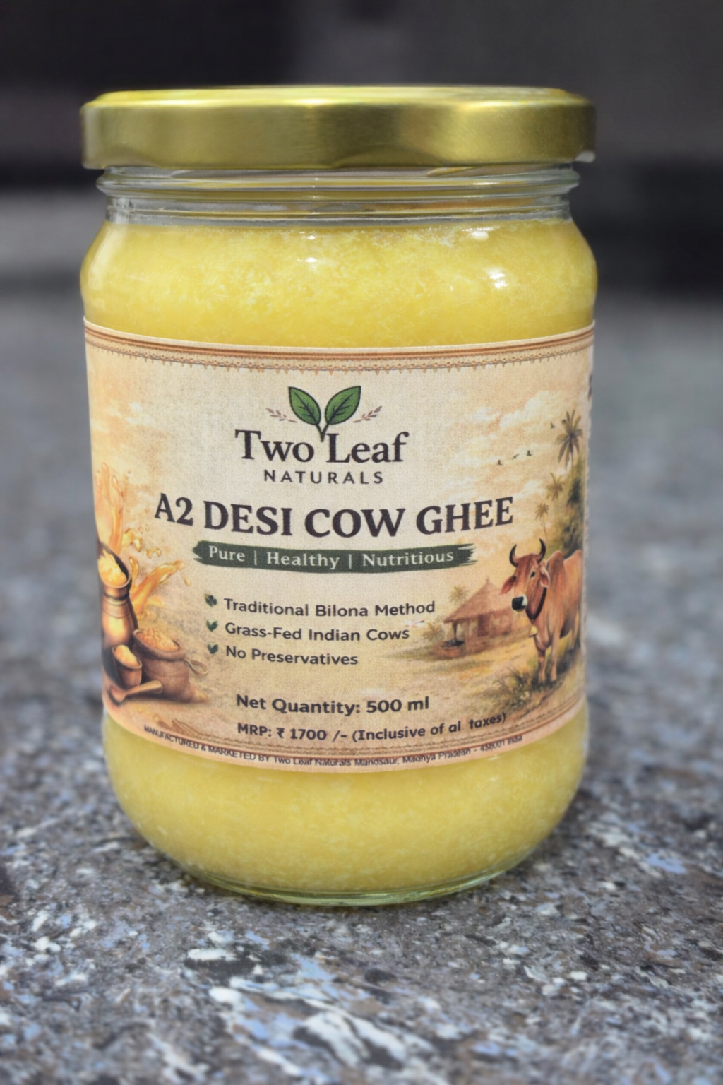 Jar of Two Leaf Naturals A2 Desi Cow Ghee on a textured surface